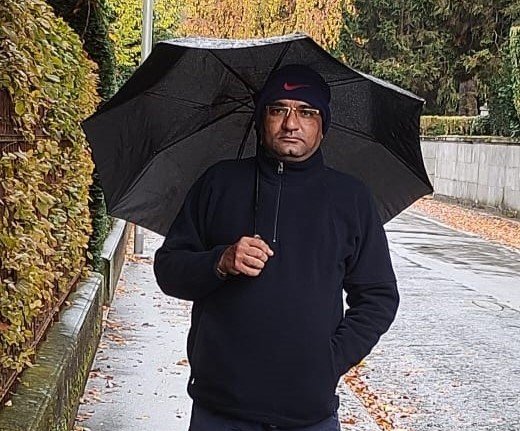 Person standing in front of a mountain range